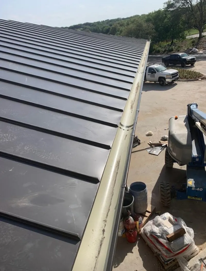 Standing seam panel and gutter detail on a metal roofing jobsite in Hanover